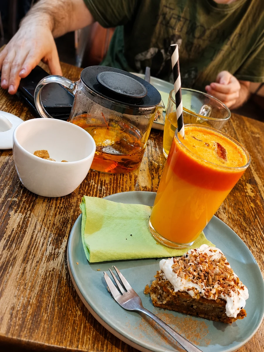 Fresh orange juice and hot drinks on a café table